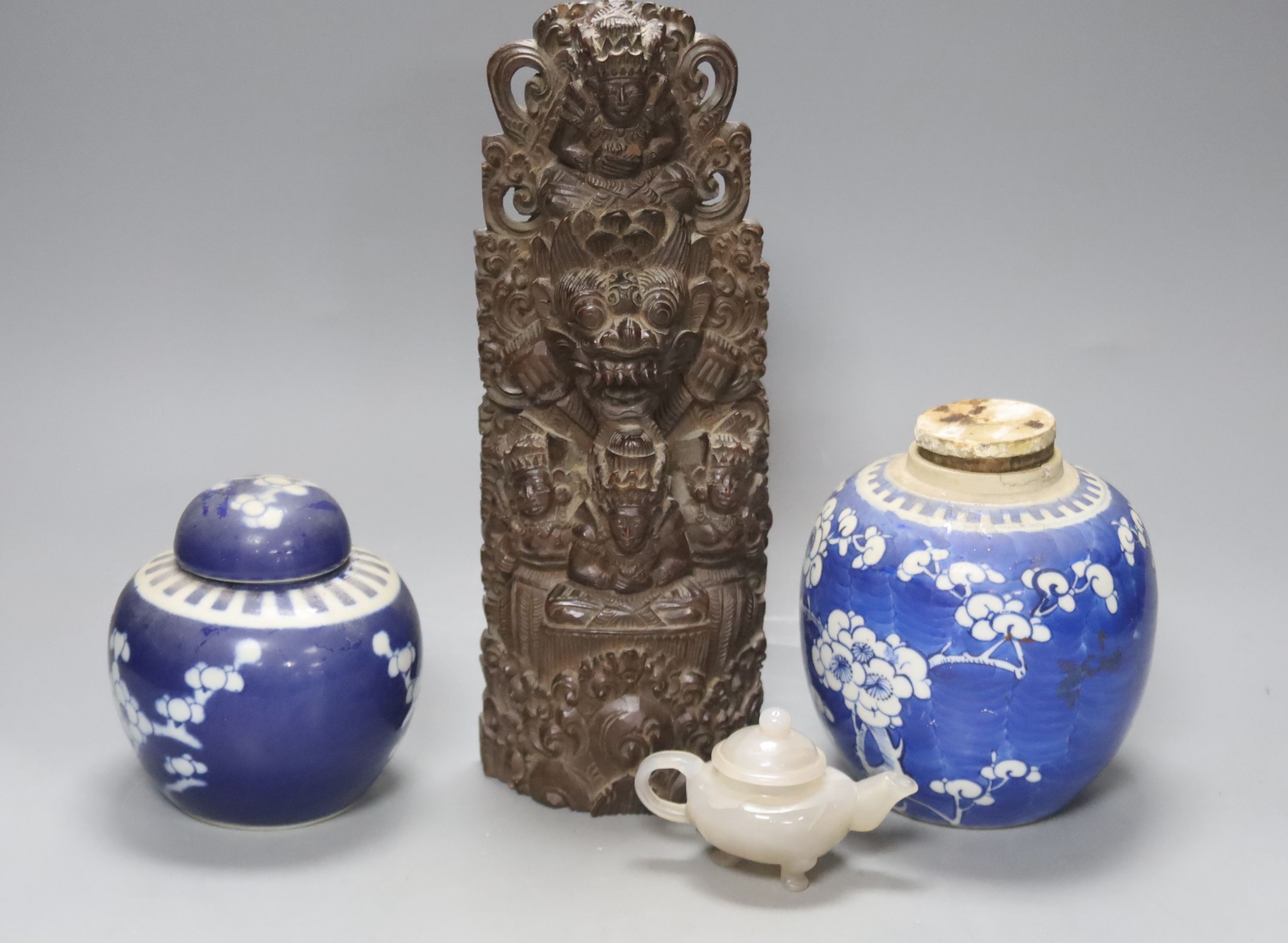 Two early 20th century Chinese blue and white jars, an agate miniature teapot and an Indonesian wood carving, length 27.5cm